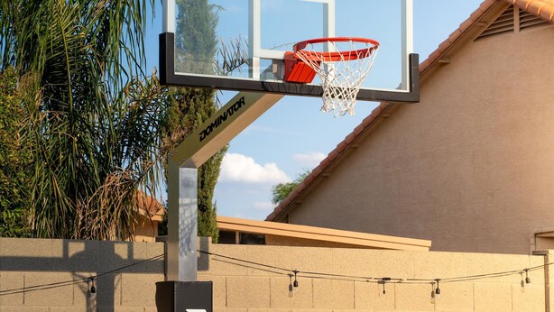 A basketball hoop with a net, mounted on a pole with a brand name visible. - Pickleball Heated Pool Spa Sleeps 16 (Peoria)