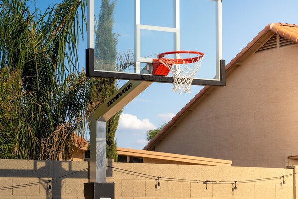 A basketball hoop with a net, mounted on a pole with a brand name visible. - Pickleball Heated Pool Spa Sleeps 16 (Peoria)