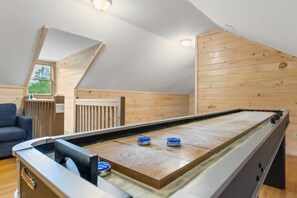A room with a pool table, a blue sofa, and wooden paneling on the walls. - 12 Min to Downtown Sleeps 12 Hot Tub Fire Pit (Blue Ridge)