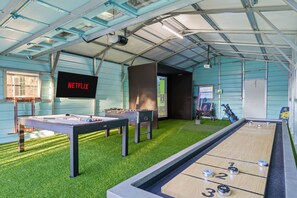 A recreational area with pool tables, a foosball table, and a shuffleboard table. - Sleeps 16 Golf Simulator Pickleball Pool Spa (Bradenton)