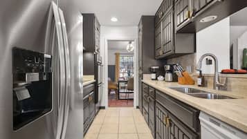 A modern kitchen with stainless steel appliances, a built-in oven, and a dishwasher.
