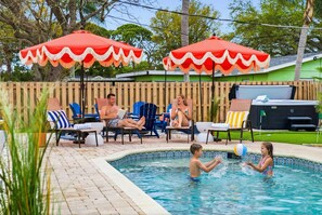 A swimming pool area with lounge chairs and umbrellas. - Palm Shell Villa - Pool - Pickleball - Hot Tub (Bradenton)