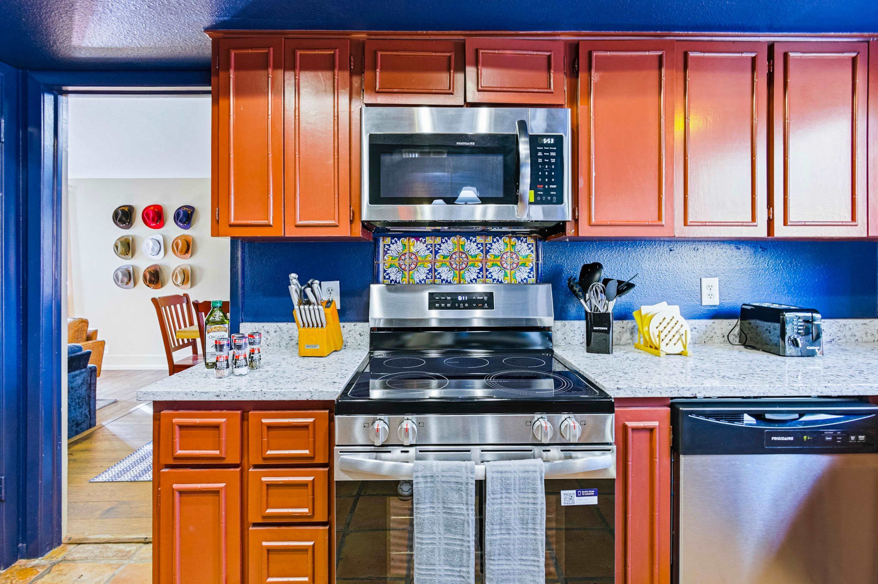 A kitchen with a stainless steel stove, microwave, and dishwasher.