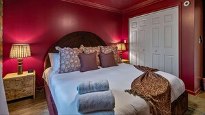 A bedroom with a large bed, two bedside lamps, a ceiling fan, and a wardrobe. - Wellsprings Retreat Smoky Mtn Views Sleeps 12 (Gatlinburg)