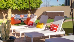 Outdoor lounge chairs with cushions, a patio table, and a potted plant. - Suncrest Retreat - Pool Pickleball Theater (Scottsdale)