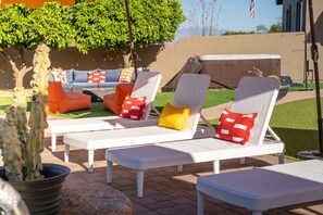 Outdoor lounge chairs with cushions, a patio table, and a potted plant. - Suncrest Retreat - Pool Pickleball Theater (Scottsdale)