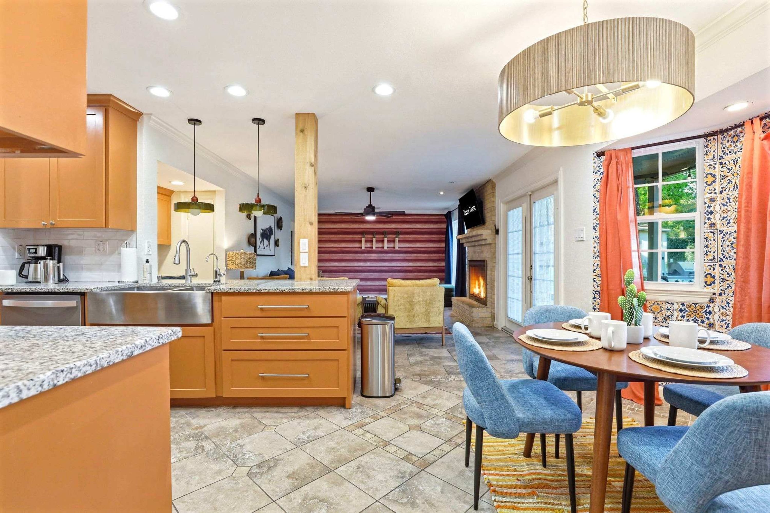 A modern kitchen with granite countertops, wooden cabinets, and a central island.
