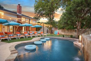 A backyard with a swimming pool, lounge chairs, and string lights. - Resort Style Backyard Pool Putt Putt Hot Tub (San Antonio)