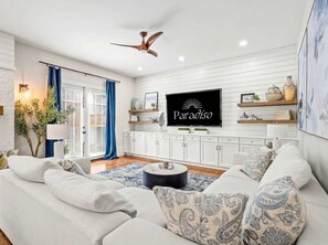 A modern living room with a sofa, a coffee table, and a television mounted on the wall. - Atlanta Beltline House City Center (Atlanta)