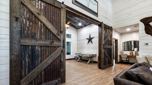 A rustic interior with exposed wooden beams, a star decoration, and a cozy seating area. - Broken Bow Luxury Cabin Hot Tub Playset Games (Broken Bow)