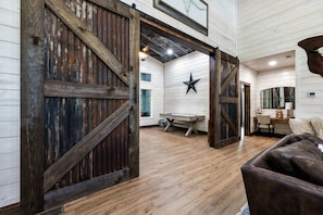 A rustic interior with exposed wooden beams, a star decoration, and a cozy seating area.