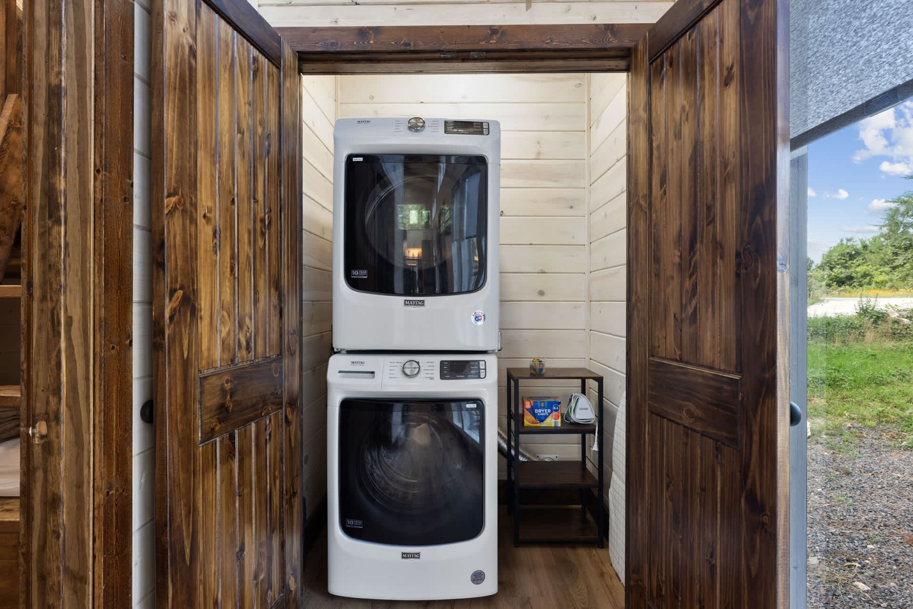 A laundry room with two stacked Maytag washers and dryers.