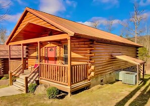 A log cabin with a porch, a staircase, and a small attached structure. - Mins to DT Gatlinburg Hot Tub Community Pool (Gatlinburg)