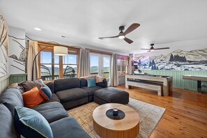A modern living room with a sectional sofa, a round coffee table, and a pool table. - Mins to Hatley Pointe Hot Tub Views Sauna (Mars Hill)