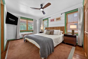 A bedroom with a bed, a nightstand, a TV, and a ceiling fan. - Mins to Hatley Pointe Hot Tub Views Sauna (Mars Hill)