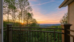 A balcony with a view of trees and a sunset. - Luxury Mtn Retreat Hot Tub Sleeps 18 Game Room (Asheville)