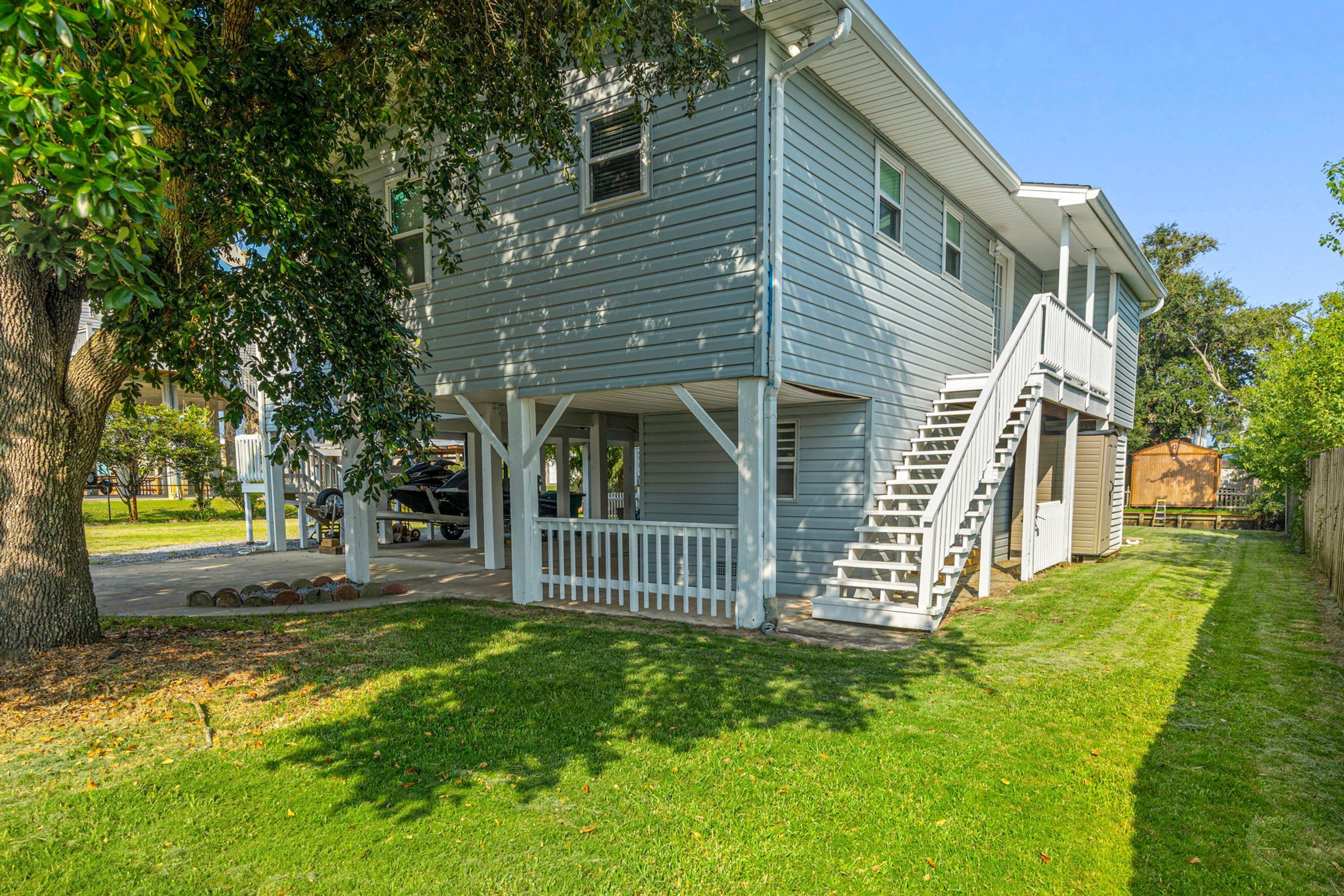 A two-story house with a covered porch and a staircase leading to the second floor.
