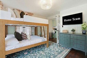 A bunk bed with pillows and a floral-patterned rug. - Charming Savannah Getaway Hot Tub Sleeps 8 (Savannah)