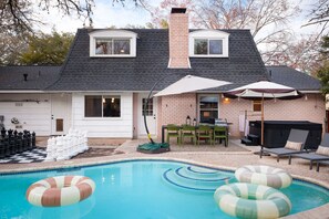 A residential property with a swimming pool, outdoor seating, and a barbecue area. - Giddy Up Getaway Pool Hot Tub Family Fun (San Antonio)