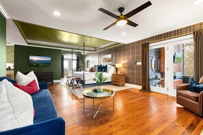 A spacious living area with a large bed, a ceiling fan, and a view through a sliding glass door. - 14k sq ft Mountaintop Estate - Private Golf Course (Fletcher)