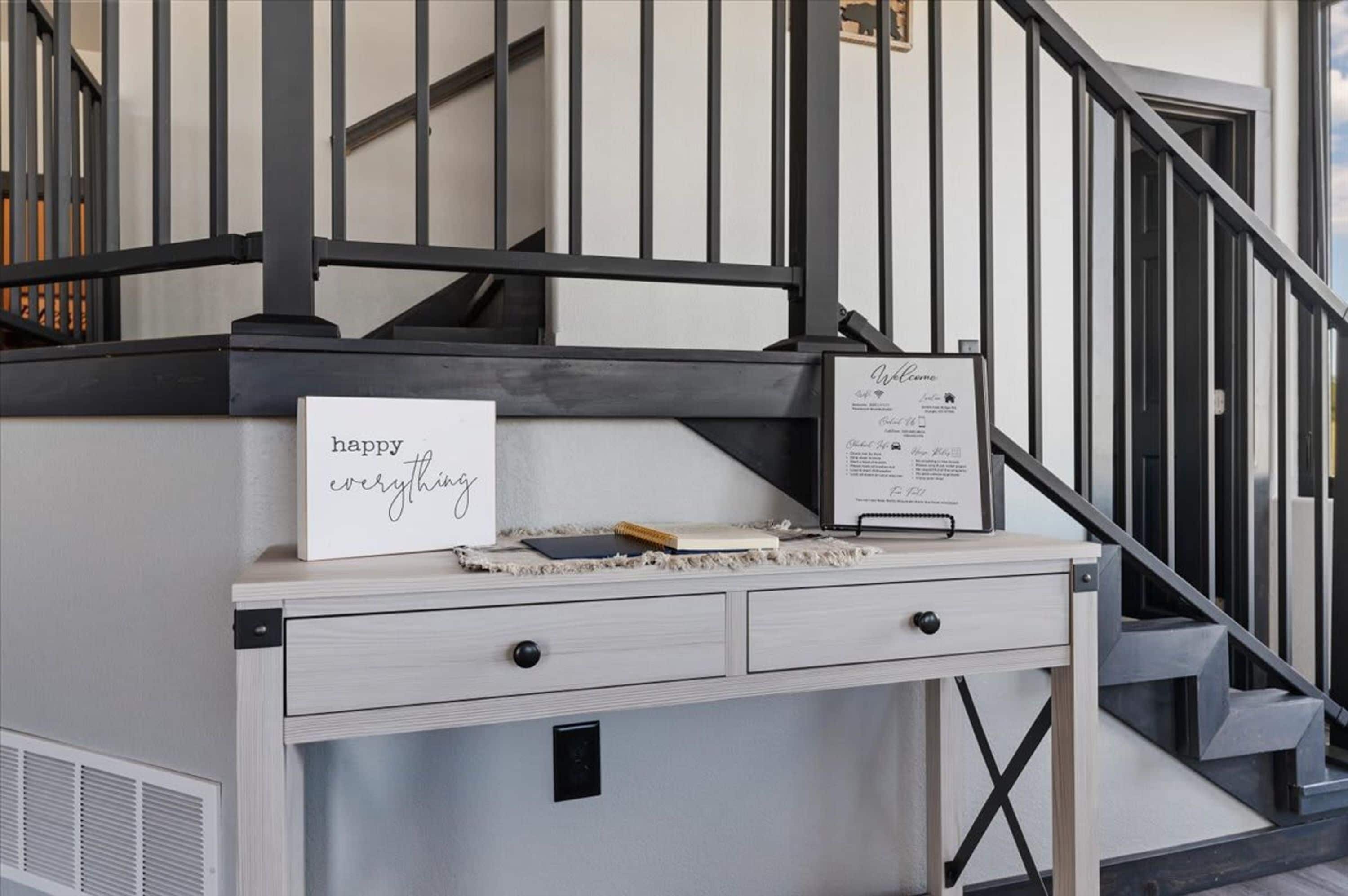 A reception desk with a sign that reads 'happy everything' and a welcome sign.