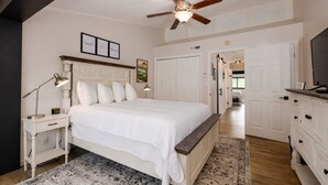 A bedroom with a bed, bedside tables, a ceiling fan, a rug, and a dresser. - Close 2 Dollywood Rustic Sleeps 6 Family Fun (Pigeon Forge)