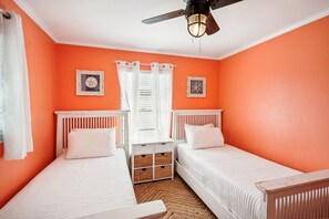 A room with two single beds, a ceiling fan, and two wall-mounted pictures. - 4 Br Bradenton Home Private Pool Outdoor Bar W D (Bradenton)