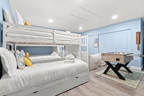 A bedroom with bunk beds, a foosball table, and a door with a keyhole. - Paradise Htd Pool Tiki Bar Hot Tub Games (Seminole)
