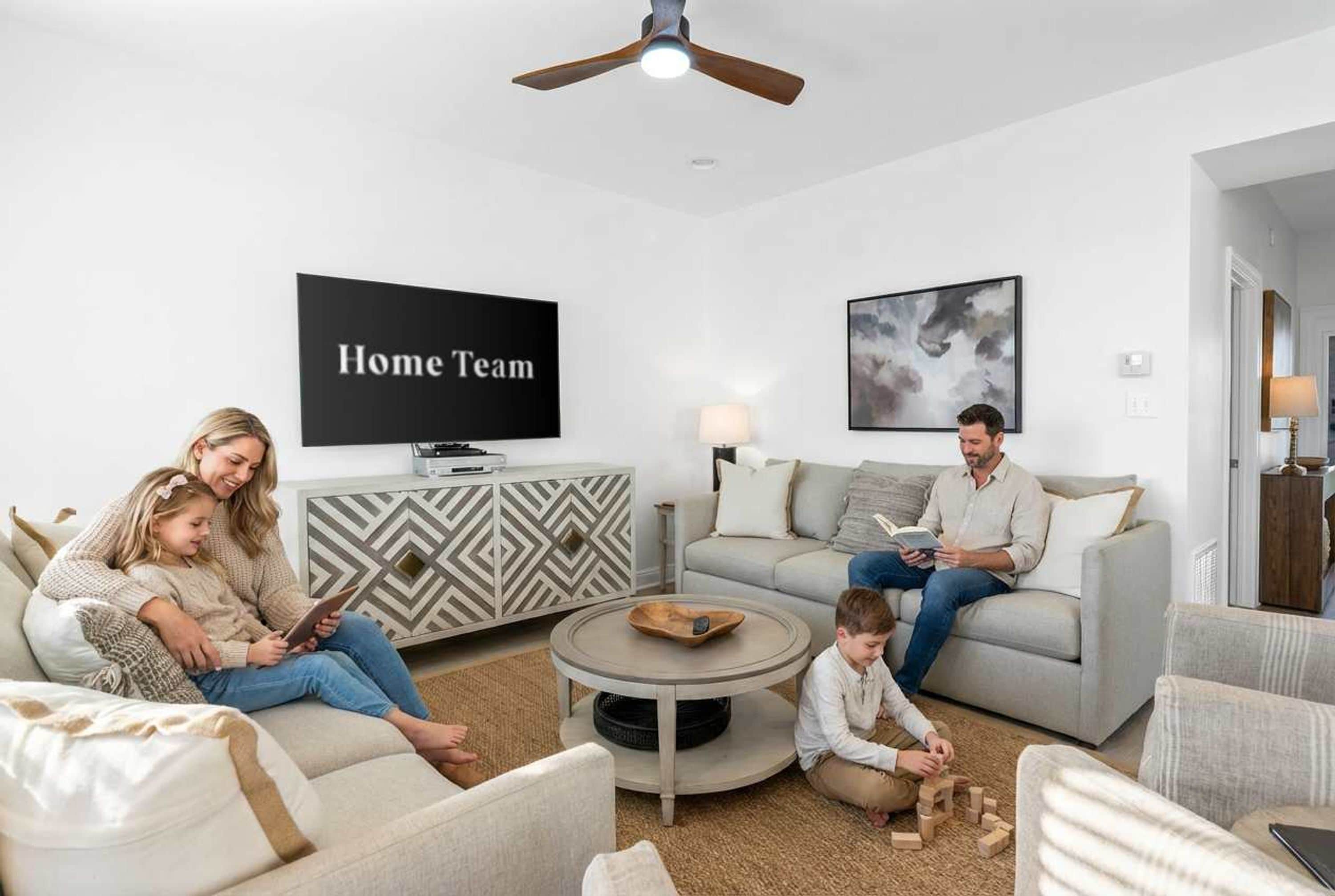 A living room with a sofa, a coffee table, and a television.