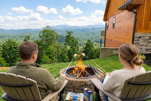 Two people sitting by a campfire with a scenic mountain view. - Sweet Mimosa Lodge Indoor Pool Hot Tub Views (Sevierville)