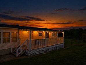 A wooden house with a porch, steps, and string lights. - 47-Acre Farm Stay Near Bell Buckle & TN Whiskey Trail (Wartrace)