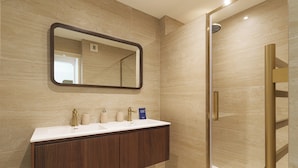 A bathroom with a vanity, a mirror, and a shower area. - Apartment & Private Garden - Deauville-sevigne (Deauville)