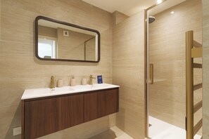 A bathroom with a vanity, a mirror, and a shower area. - Apartment & Private Garden - Deauville-sevigne (Deauville)