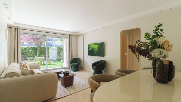 A modern living room with a sofa, chairs, a coffee table, and a dining table. - Apartment & Private Garden - Deauville-sevigne (Deauville)