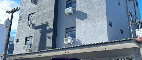 A modern building with a sign for 'AM Suites.'