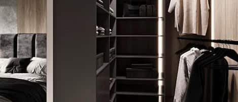 A modern bedroom with a bed, a walk-in closet with shelves, and a hanging rack.