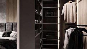 A modern bedroom with a built-in wardrobe, a bed, and a hanging closet. - A comfortable apartment in the center of Łódź (Lodz)