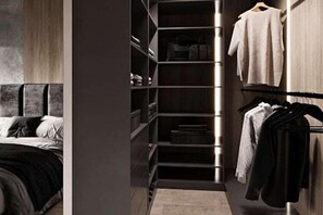Ein modernes Schlafzimmer mit Einbauschrank, einem Bett und einer Garderobe.