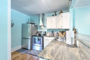 A compact kitchen with a refrigerator, oven, and microwave. - `Pirates Perch` - Walkable to everything Folly! (Folly Beach)