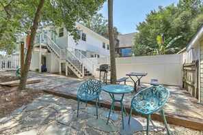 A backyard with a patio, outdoor furniture, a staircase, and a fence. - `Pirates Perch` - Walkable to everything Folly! (Folly Beach)