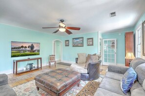 A living room with a ceiling fan, a sofa, a loveseat, and a coffee table. - `Pirates Perch` - Walkable to everything Folly! (Folly Beach)