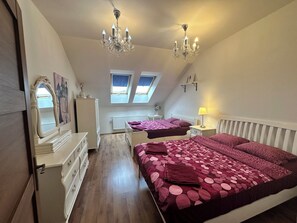 A bedroom with two beds, a dresser, a mirror, a radiator, and a chandelier. - Spacious Karlín 2BR+Living Room. Metro 1 Min. Elevator. (Hlavní město Praha)