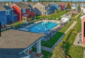 A residential area with a swimming pool surrounded by houses. - Monkey Island Nautical Escape (Afton)