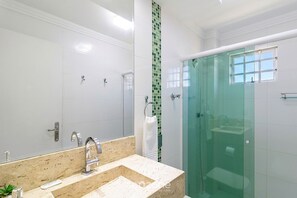 A modern bathroom with a glass shower enclosure, a large mirror, and a marble countertop. - Apt. w/ Balcony 510m From Shopping Maf0103 (Itapema)