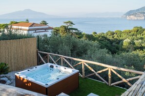 A hot tub on a deck with a view of the sea and mountains. - Maison Regina Giovanna - A Window into Paradise (Sorrento)