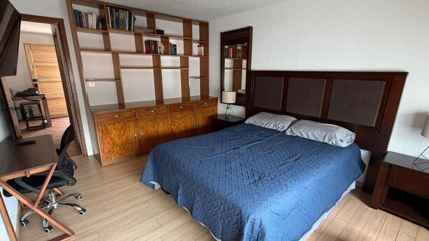 A bedroom with a bed, a desk, a chair, a wardrobe, and a bookshelf. - Casa Andares 3 REC Y 3 BANOS (Zapopan)