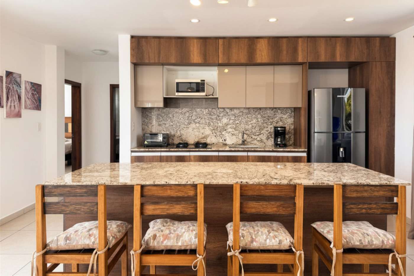 Coffee/tea maker, fridge, microwave, dining table