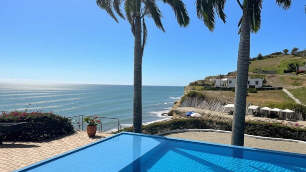 Ein Infinity-Pool mit Blick auf den Ozean und eine Hügelsicht mit Gebäuden.