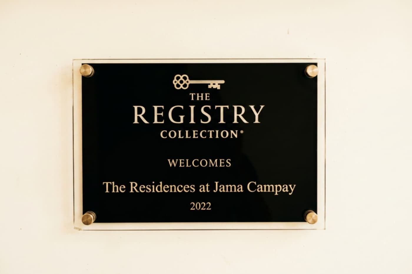 A plaque with the text 'THE REGISTRY COLLECTION' and 'WELCOMES The Residences at Jama Campay 2022'.