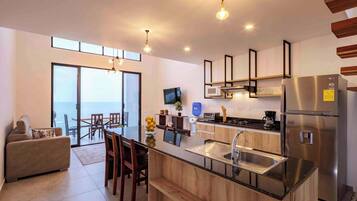 Coffee/tea maker, fridge, microwave, dining tables
